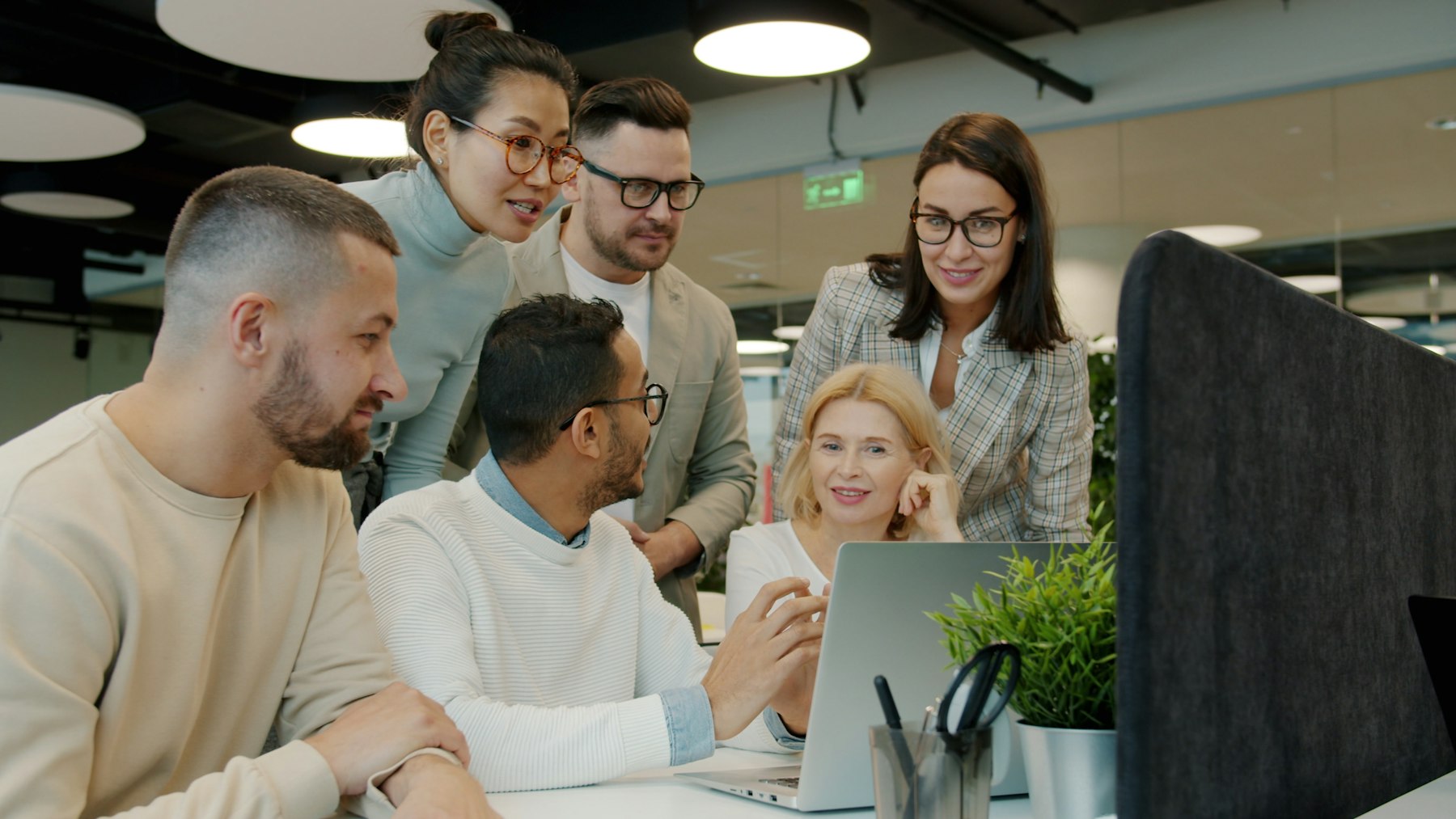 Team reviewing options on a laptop